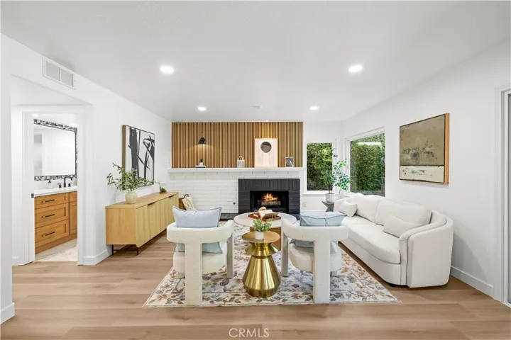 Living area with modern finishes, centered around a cozy fireplace and abundant natural light.