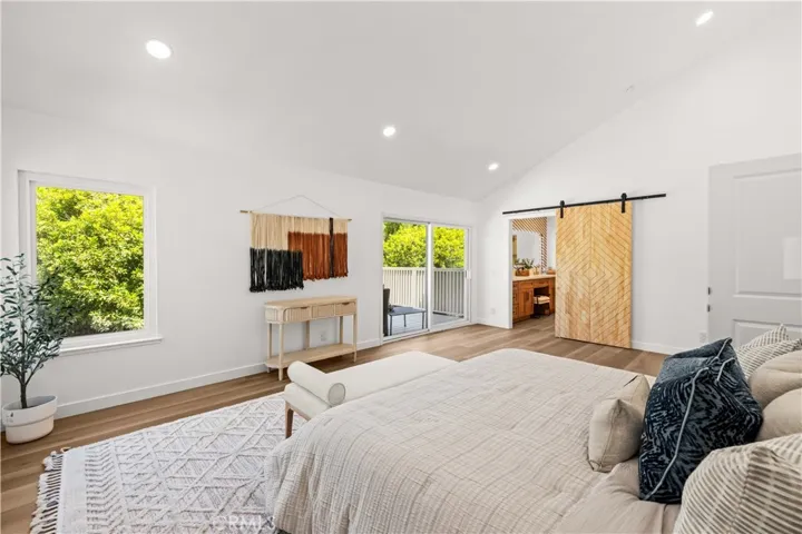Spacious primary bedroom featuring abundant natural light, direct balcony access, and a bright open layout.