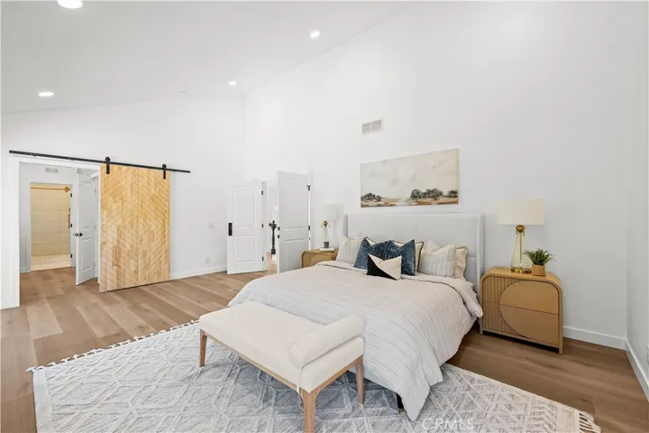 Well-sized bedroom featuring high ceilings, modern finishes, and a clean, comfortable layout.