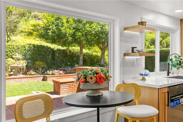 Breakfast nook with large window, offering backyard views and abundant natural light.