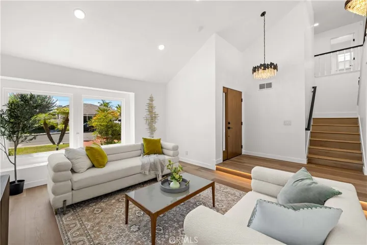 Bright Living Room with Large Windows – Open and airy with natural light and front yard views.