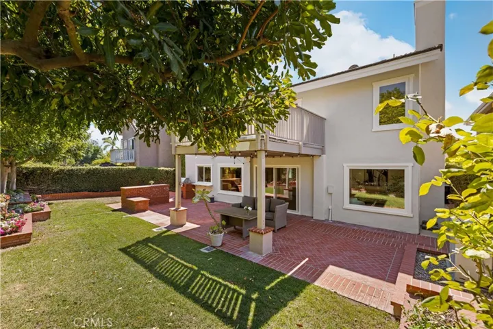 Alternate view of the backyard highlighting the patio, lawn, and inviting outdoor living space.