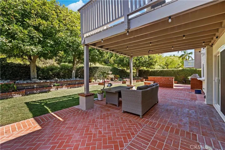Backyard patio with covered seating area, offering a great space for relaxing and outdoor gatherings.