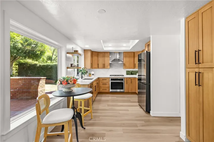 Kitchen with breakfast nook, featuring natural light and a view of the backyard.