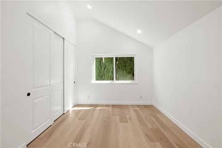 Bedroom 3 with vaulted ceilings, natural light, and a clean, comfortable layout.