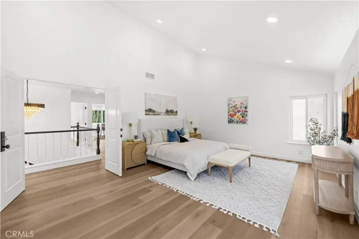 Spacious bedroom featuring high ceilings, abundant natural light, and a clean, modern layout.