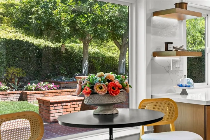 Dining nook with large window, offering backyard views and natural light.