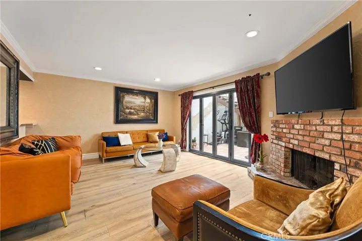 Family room w/ Fireplace + access to deck & pool