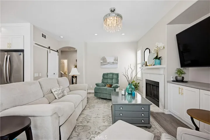 FAMILY ROOM WITH FIREPLACE AND SLIDER TO POOL AND PATIO