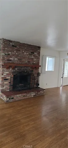 FIREPLACE IN THE LIVING ROOM.  SEE THE HARDWOOD FLOORS