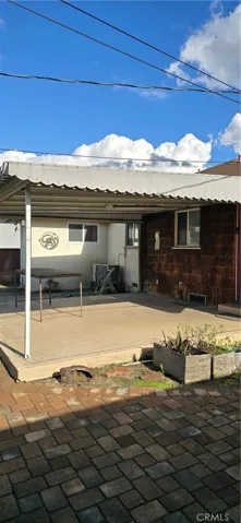 COVERED PATIO OFF THE BACK OF THE HOUSE.