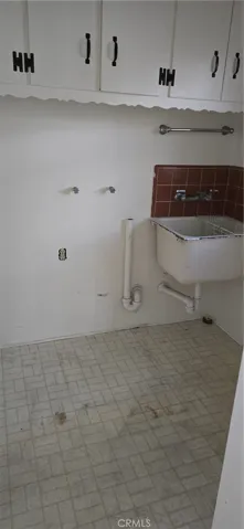 LAUNDRY ROOM WITH A FUNCTIONAL LAUNDRY ROOM SINK.