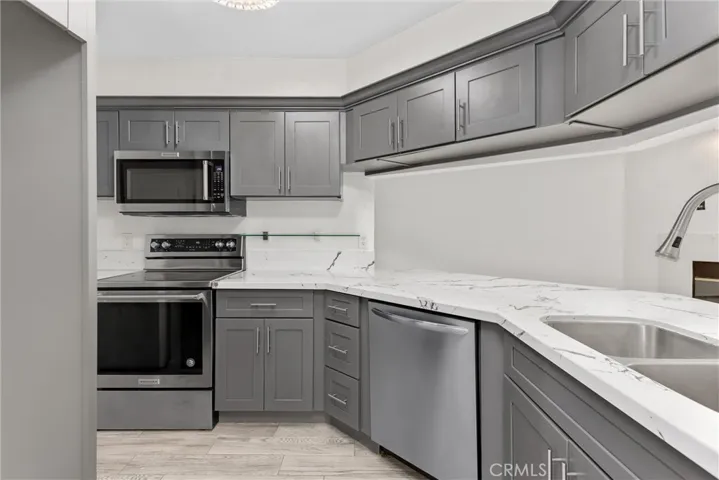 Kitchen with Quartz counter tops, dishwasher, range-stove, & microwave