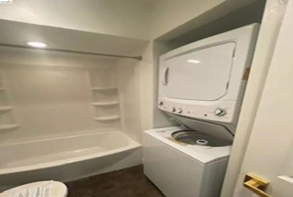 Laundry area featuring stacked washer / dryer