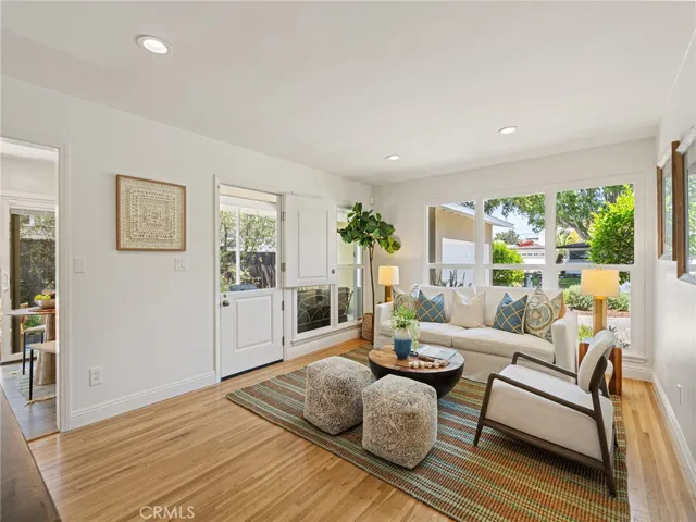 Living room with dutch door and views of the private porch and trees and street view.