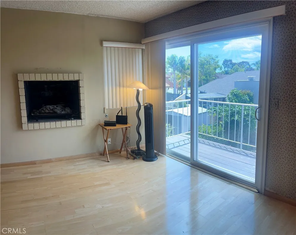 Close up view of the Primary Suite Fireplace and exit door to the balcony. You can see the overlooking view from here.