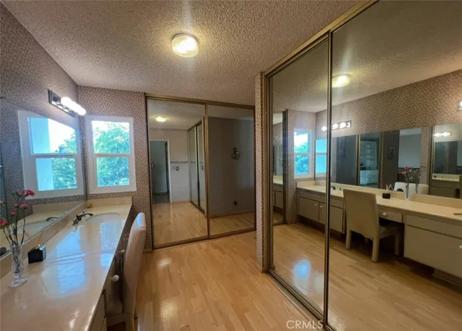 Primary Bathroom view of the His and Her Closets and sinks.