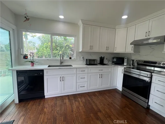 Upgraded kitchen with quartz counter top and stainless steel appliances.  Oak flooring.
