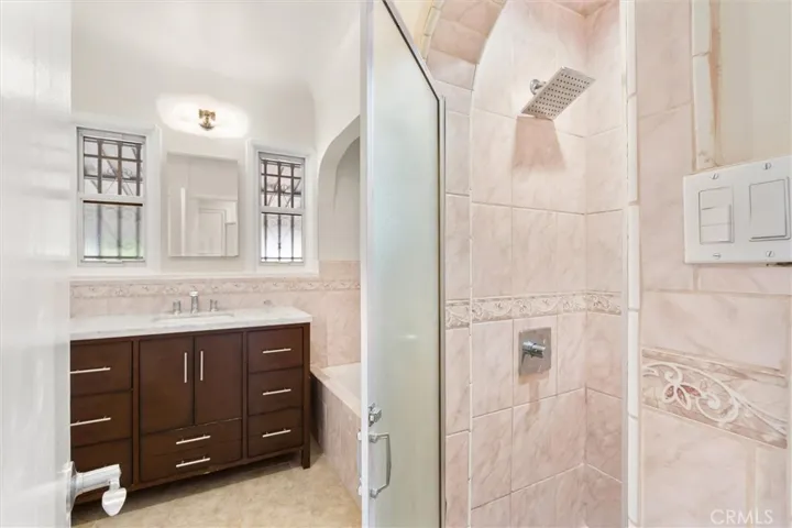 Hall bathroom with separate tub & walk in shower.