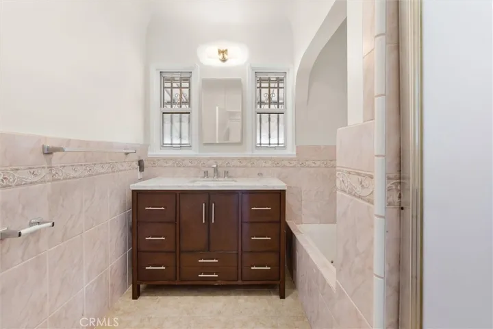 Hall bathroom with separate tub & walk in shower.