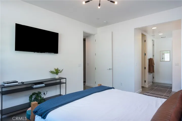 Guest bedroom with walk-in bathroom and TV