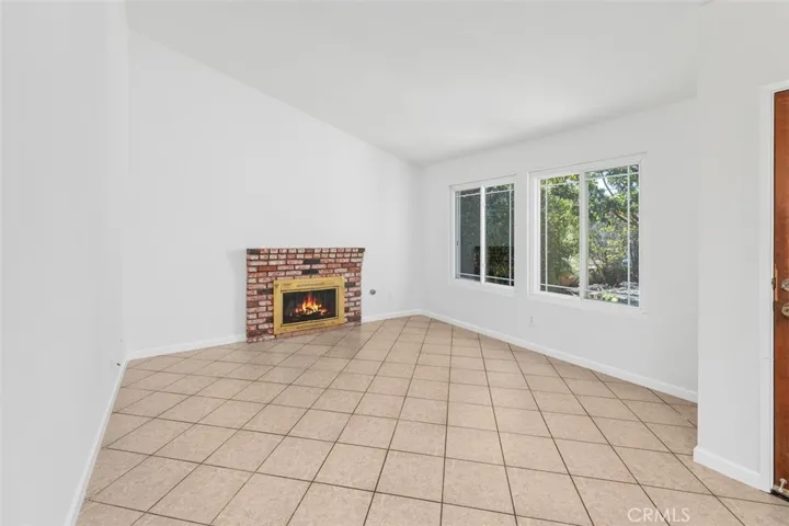 Another view of the living area highlights the generous wall space, natural light, and easy-flow layout. The room offers a bright setting for both everyday living and entertaining.