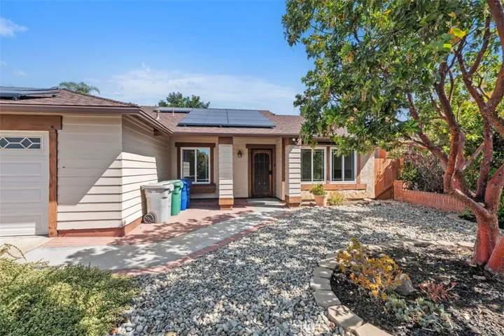 Gated front courtyard adds charm and a sense of separation from the street, offering a pleasant space to greet guests or enjoy a quiet moment outdoors. The entry sequence feels both inviting and secure.