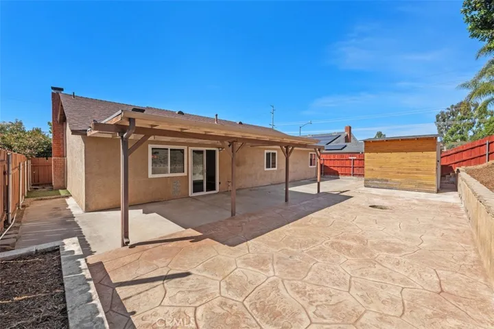 Backyard offers a wide, usable outdoor area with patio space and room to customize for gardening, play, or additional seating. The low-maintenance setup supports easy enjoyment.
