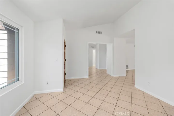 Clean interior sightline shows the home’s simple, functional layout and fresh updated feel. Light flooring and neutral walls create a move-in ready backdrop.