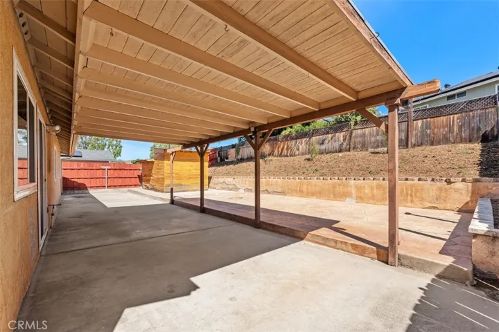 Another view beneath the covered patio highlights the depth of the space and its flexibility for entertaining. This area extends the home’s living potential outdoors.