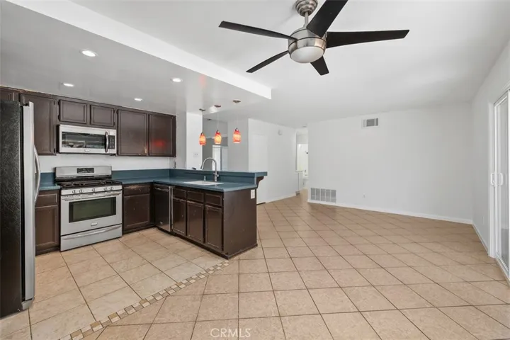Updated kitchen features dark cabinetry, stainless steel appliances, and a practical layout designed for everyday ease. Ample counter space supports both meal prep and entertaining.