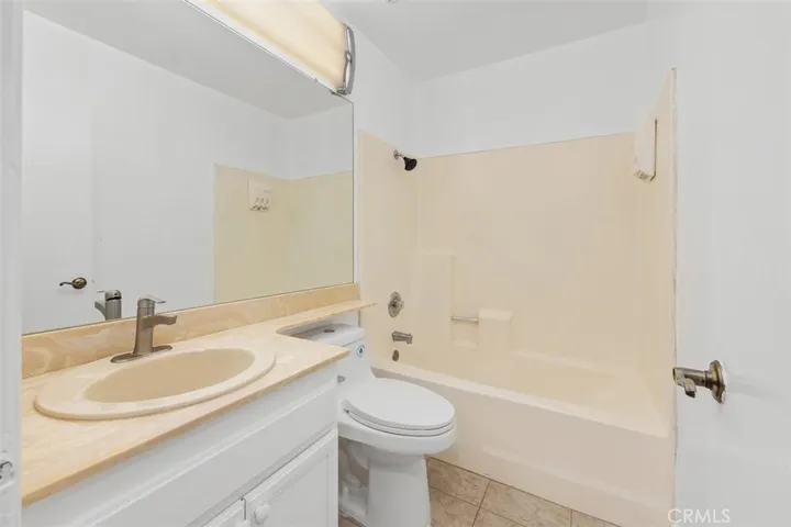 Full bathroom includes a large vanity and tub-shower combination, offering both convenience and everyday functionality. The layout is spacious and easy to use.