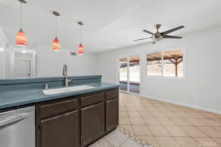 Breakfast bar and adjacent dining area create an easy flow for casual meals and conversation. Pendant lighting adds a warm touch and helps define the space.