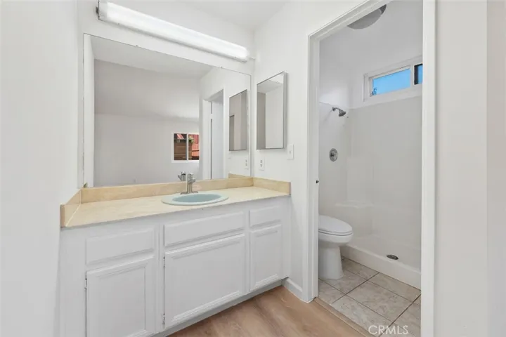 Vanity area offers useful storage and a bright, practical setup for daily routines. The clean design keeps the space feeling fresh and functional.