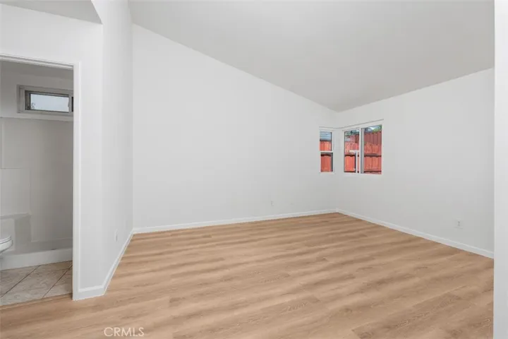 Bright bedroom features updated flooring, neutral walls, and a simple layout that is easy to personalize. The space feels fresh, comfortable, and ready to enjoy.