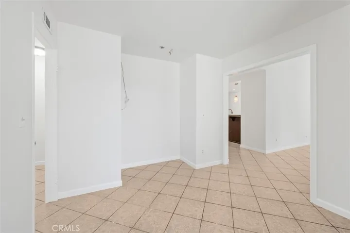 Additional angle of the dining area shows the open configuration and easy connection to the rest of the home. The neutral finishes keep the space feeling fresh and versatile.