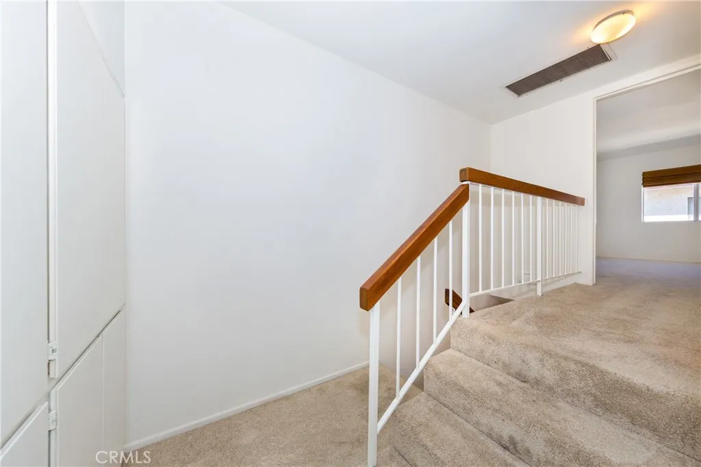 Top of stairs, view of cabinets in hallway