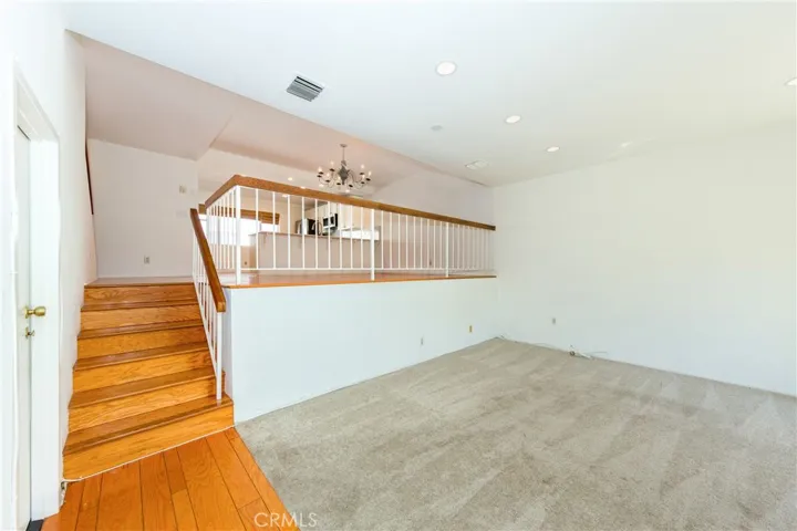Living room with stairs to dining area mid level