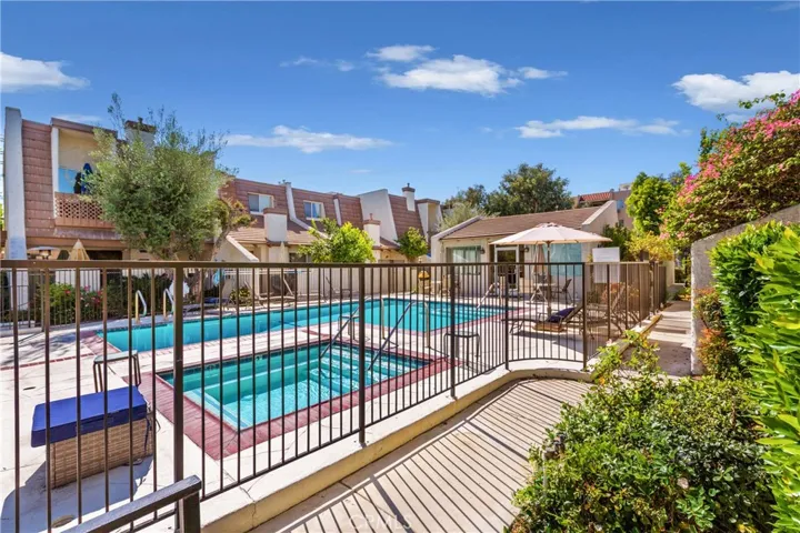 Gated pool & spa area with view of pool recreation room.