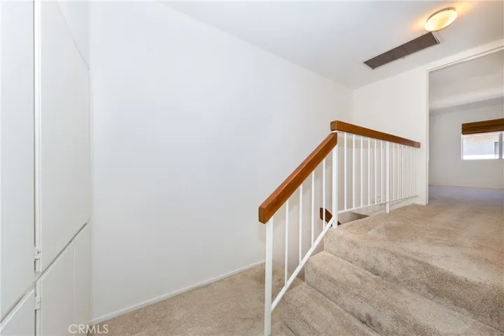 Top of stairs, view of cabinets in hallway