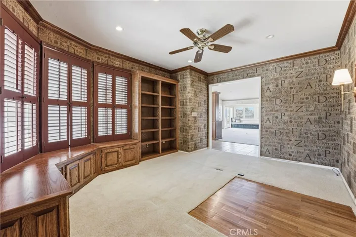 One of two generously sized secondary bedrooms currently configured as a home office space.