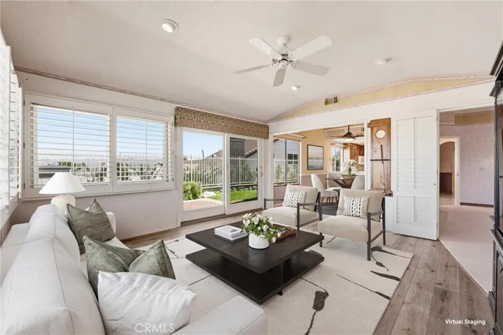 This photo showcases the open and inviting connection between the family room and the eat-in kitchen, highlighting the natural flow and functionality of this living space (virtually staged).