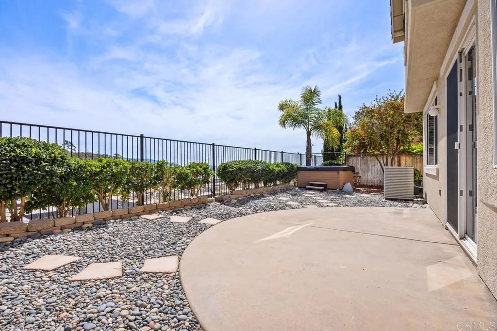 Patio with private spa leads to large garden area