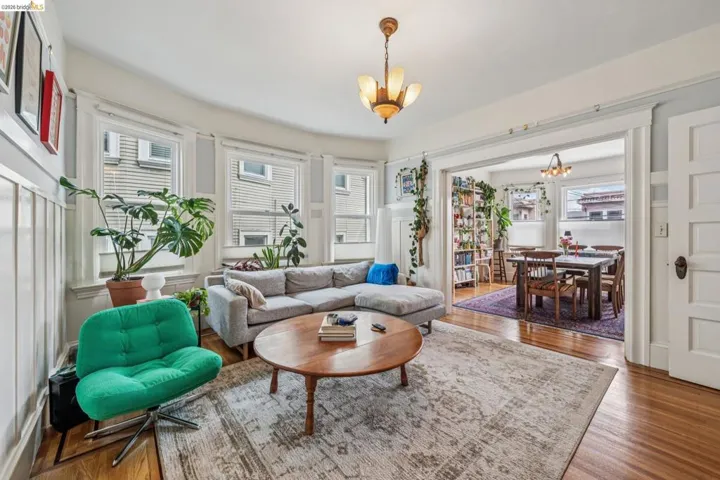 Gorgeous living room with oak flooring and wainscoting.