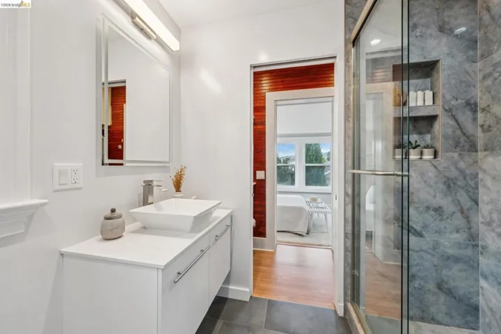 Updated primary suite bathroom with walk in rain shower.