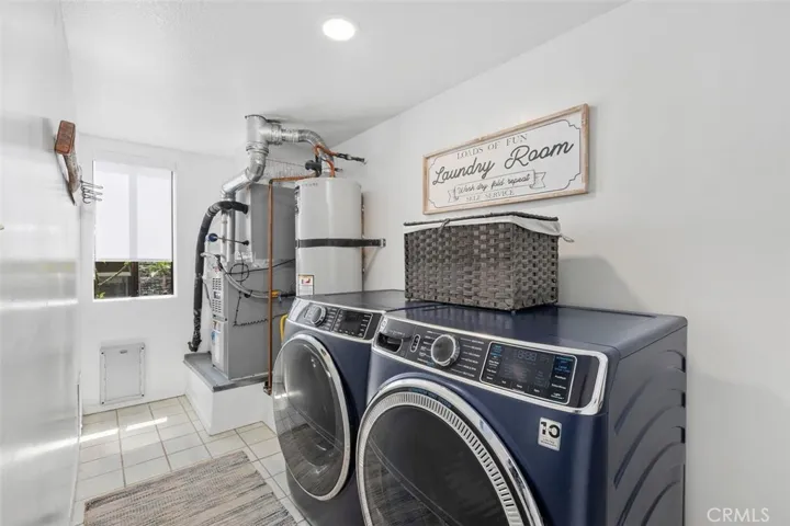 The laundry room houses the newer ('23) water heater and ('23) heater.  Just outside is the newer ('23) A/C.