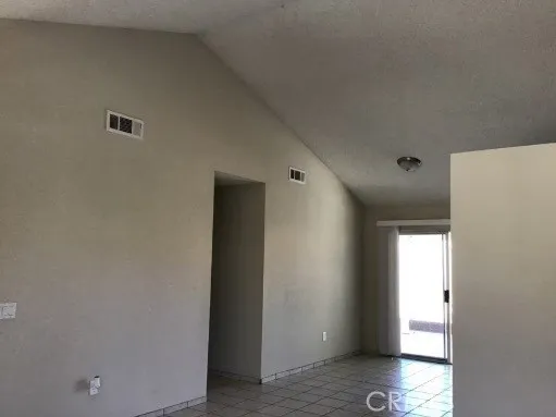 Cathedral ceilings in living room, dining area and kitchen
