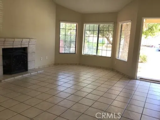 Easy care tile flooring - living room features bay window and fireplace