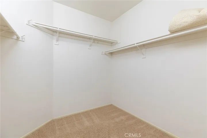 Primary bedroom walk-in closet