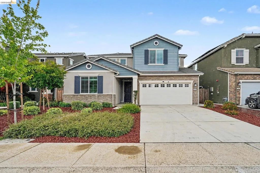 Contemporary two-story residence with a two-car garage and a concrete driveway